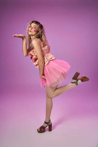 Attractive woman in tooth fairy costume with face stickers standing on one leg and blowing kiss — Stock Photo