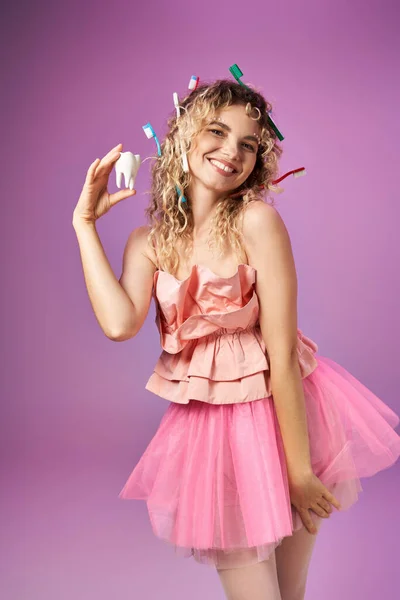 Attractive blonde woman with toothbrushes in hair posing and looking at camera, tooth fairy concept — Stock Photo