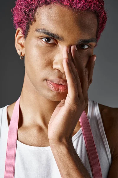 Portrait of handsome pink haired man with his palm on face looking at camera, fashion and style — Stock Photo