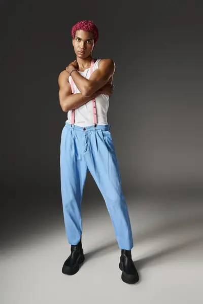 Good looking man looking at camera wearing blue pants with arms crossed on chest, fashion concept — Stock Photo