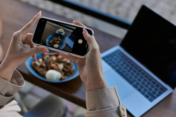 Cropped view of woman taking photo on her smartphone of belgian waffles with ice cream, female hands — Stock Photo
