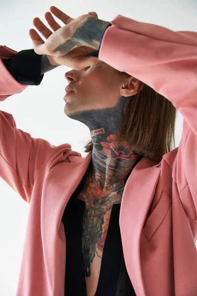 Vertical shot of young sexy man posing with hands near face and closed eyes, fashion concept — Stock Photo