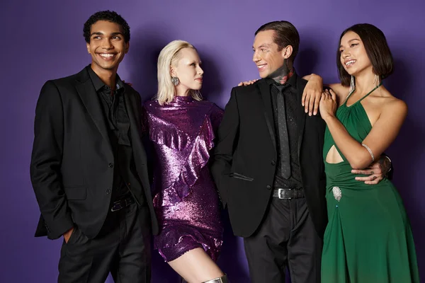 New year 2024, happy interracial male and female friends in festive attire hugging on purple — Stock Photo