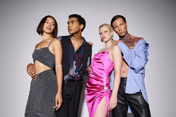 Stylish interracial group of people in party attire posing on grey backdrop, 2024 New Year concept — Stock Photo