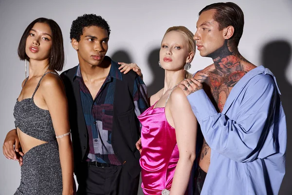 Four stylish interracial friends posing together in evening attire on grey, New Year 2024 concept — Stock Photo