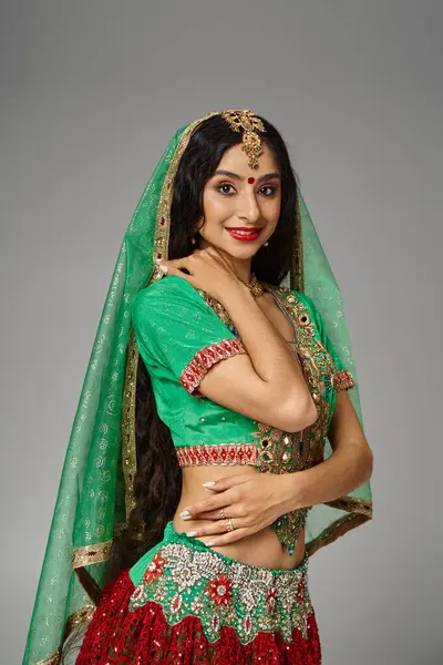 Vertical shot of attractive indian woman with long hair and bindi dot smiling joyfully at camera — Stock Photo