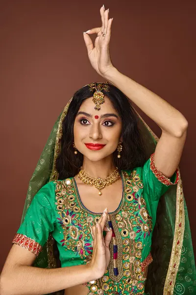 Vertical shot of pretty joyful indian woman with veil and bindi gesturing actively and looking away — Stock Photo
