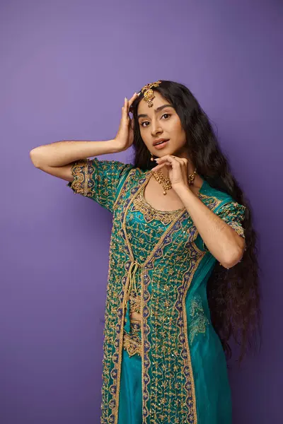 Vertical shot of attractive indian woman in national costume with hands on face looking at camera — Stock Photo