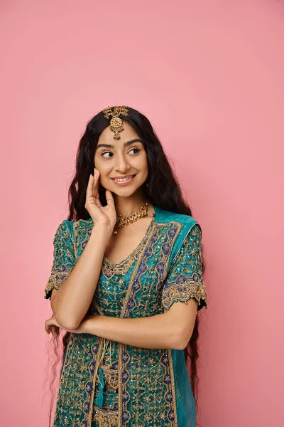 Vertical shot of attractive jolly indian woman posing with her hand near face and looking away — Stock Photo