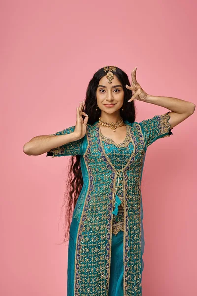 Vertical shot of attractive young indian woman in blue sari with accessories gesturing lively — Stock Photo