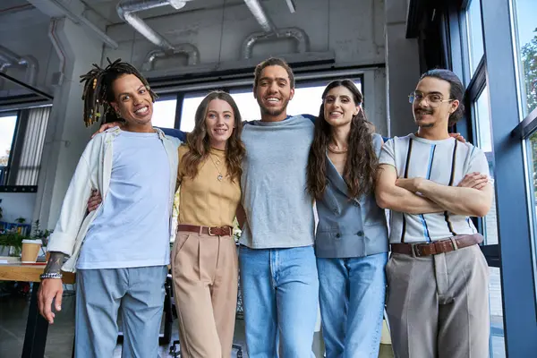 Stylish and joyful multicultural managers looking at camera in modern office, successful teamwork — Stock Photo