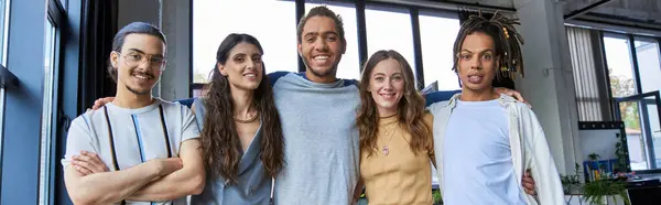 Successful and stylish multiethnic colleagues looking at camera in modern office, horizontal banner — Stock Photo