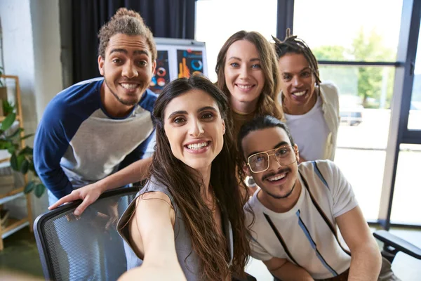 Portrait of diverse multiethnic team smiling at camera in modern office, successful entrepreneurs — Stock Photo