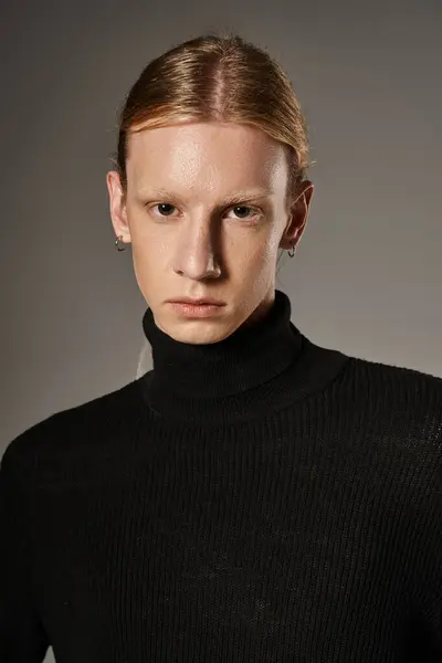 Vertical shot of red haired androgynous model in black stylish turtleneck looking at camera — Stock Photo