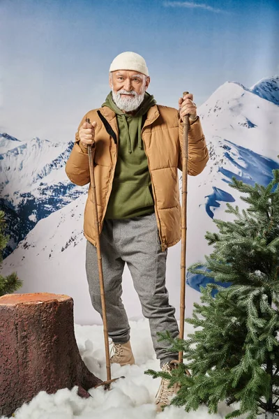 Sporty Santa in warm jacket and white hat standing on skis near tree stump, winter concept — Stock Photo