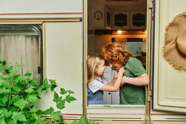 Joyful brother and sister having fun inside trailer home, happiness and siblings relationship — Stock Photo
