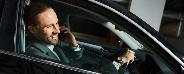 Cheerful elegant man talking happily by phone behind steering wheel, business concept, banner — Stock Photo