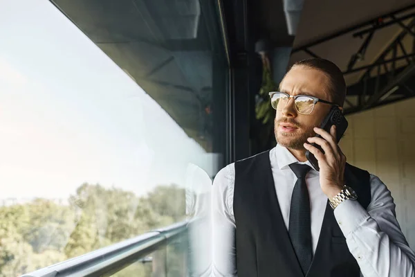 Appealing good looking man with dapper style talking by phone next to window, business concept — Stock Photo