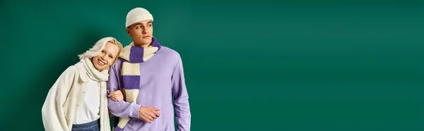 Winter attire banner, happy woman leaning on man in stylish clothing on turquoise backdrop — Stock Photo
