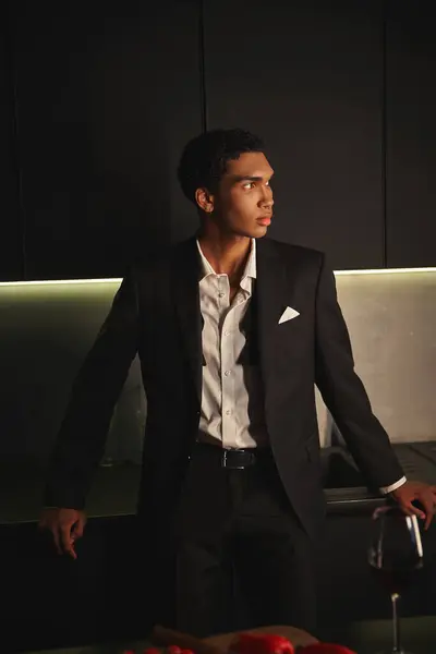 Handsome young african american man with elegant dapper style posing in kitchen and looking away — Stock Photo