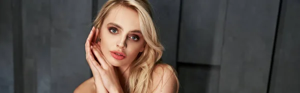 Beautiful blonde woman in elegant stylish dress posing and looking straight at camera, banner — Stock Photo