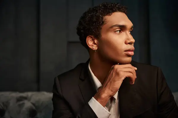 Appealing good looking african american male model in evening attire posing and looking away — Stock Photo