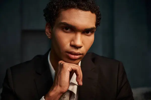 Appealing good looking african american male model in elegant suit posing and looking at camera — Stock Photo