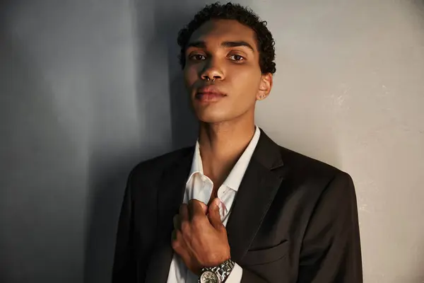 Appealing handsome african american man in elegant suit with piercing in nose looking at camera — Stock Photo