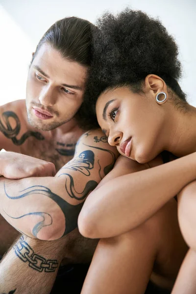 Good looking young multiracial couple in underwear sitting close to each other, togetherness — Stock Photo