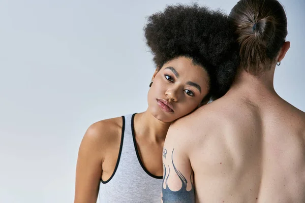 Beautiful african american woman in underwear lovingly putting her head on shoulder of her boyfriend — Stock Photo