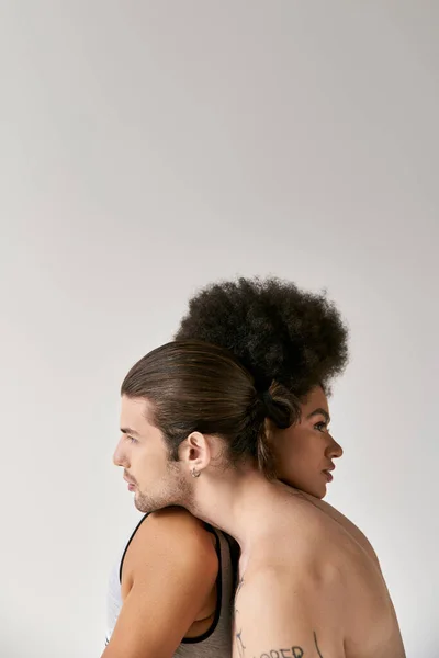 Atraente jovem mulher afro-americana e seu namorado tatuado abraçando calorosamente, casal sexy — Fotografia de Stock