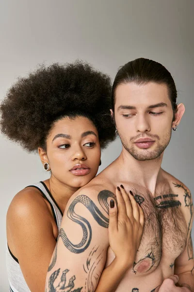 Beautiful young african american woman hugging her good looking boyfriend from behind, sexy couple — Stock Photo