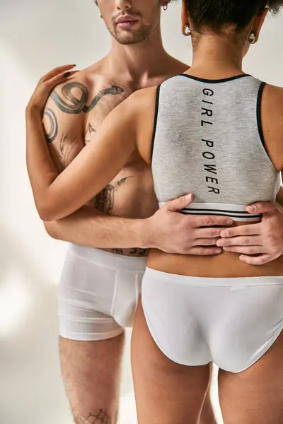 Cropped view of african american woman hugging lovingly her young tattooed boyfriend, sexy couple — Stock Photo