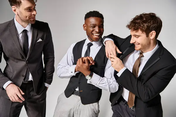 Cheerful attractive multicultural friends in business casual outfits smiling and having great time — Stock Photo