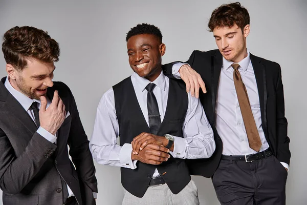 Happy young multicultural friends in business casual outfits smiling and having great time — Stock Photo