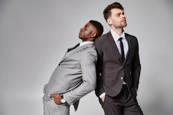 Two handsome stylish multicultural male models in business smart attires posing on gray backdrop — Stock Photo