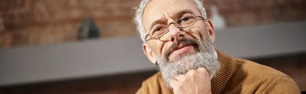 Portrait of handsome middle aged psychologist in glasses looking at camera during work, banner — Stock Photo