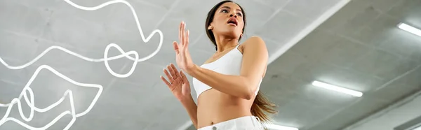 Artistic african american woman in white sports top rehearsing in modern studio, horizontal banner — Stock Photo