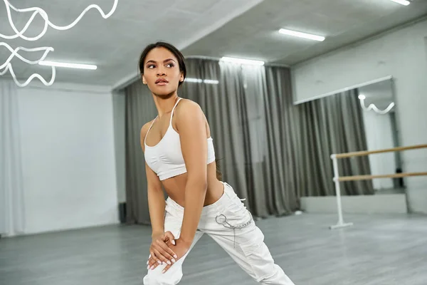 Graceful african american dancer in black crop sweater rehearsing in dance hall, horizontal banner — Stock Photo