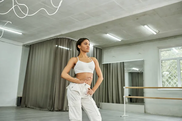 Graceful african american dancer in black crop sweater rehearsing in dance hall, horizontal banner — Stock Photo