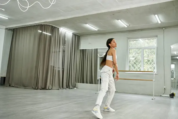 Graceful african american dancer in black crop sweater rehearsing in dance hall, horizontal banner — Stock Photo
