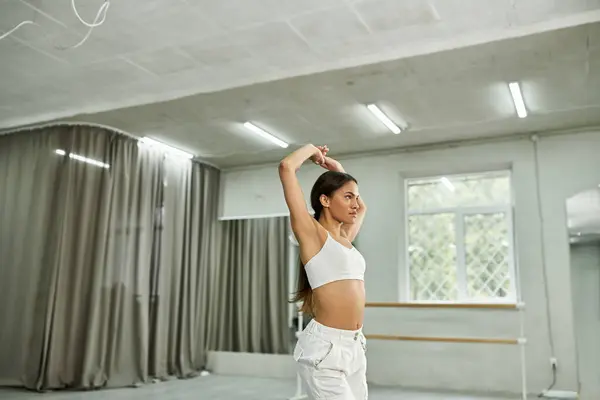 Graceful african american dancer in black crop sweater rehearsing in dance hall, horizontal banner — Stock Photo