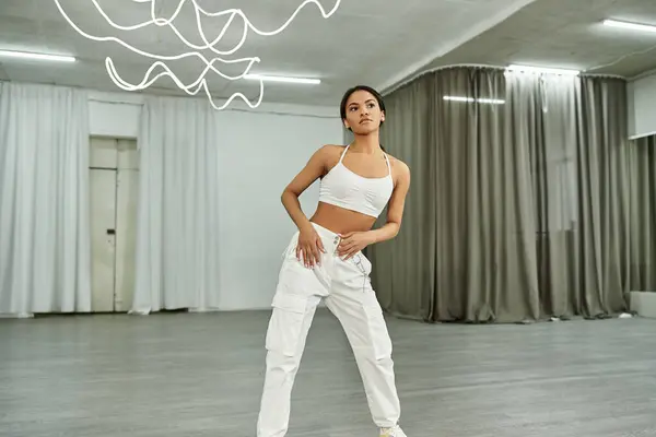Graceful african american dancer in black crop sweater rehearsing in dance hall, horizontal banner — Stock Photo