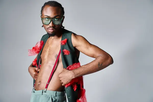 Stylish appealing african american man with sunglasses posing in motion and looking at camera — Stock Photo