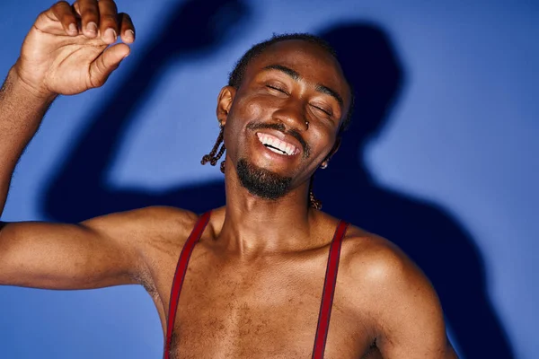 Merry african american doctor with glasses waving at mobile phone camera and smiling happily — Stock Photo