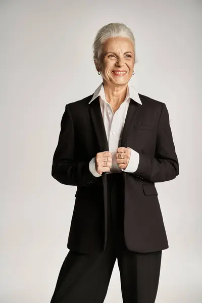 Business portrait of happy middle aged businesswoman in white shirt and blazer looking away — Stock Photo