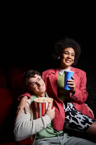 Happy multiethnic couple in retro clothes having great time at cinema on date on Valentines day — Stock Photo