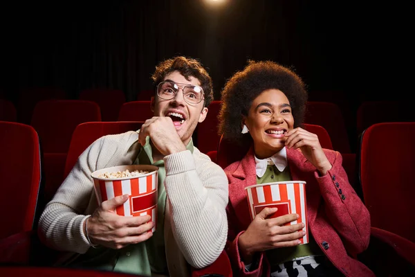 Cheerful young diverse couple in retro attires with 3d glasses having great time on their date — Stock Photo