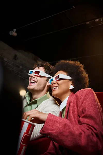 Jolly diverse couple with retro 3d glasses enjoying movie at cinema on date on Valentines day — Stock Photo