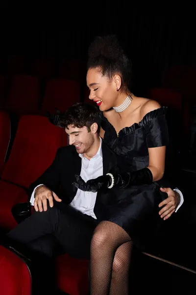 Allegro bello cercando coppia diversificata sorridente felicemente mentre al cinema in data il giorno di San Valentino — Foto stock